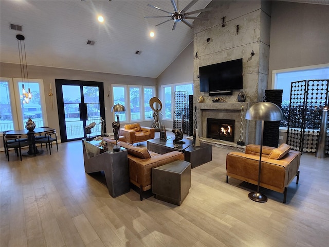 living room featuring ceiling fan, light hardwood / wood-style floors, a large fireplace, high vaulted ceiling, and wooden ceiling