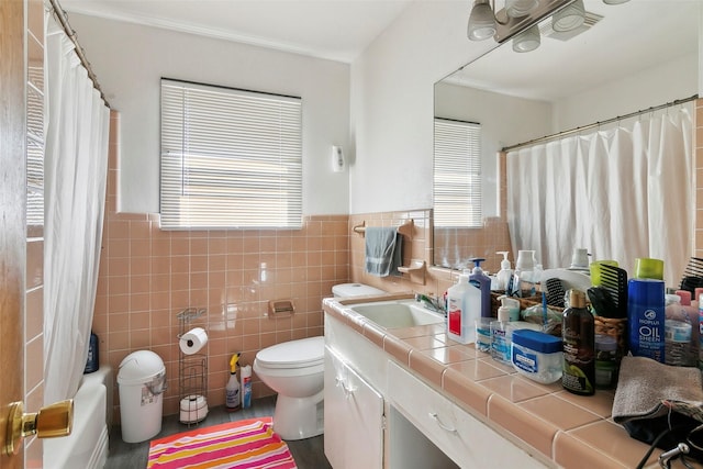 full bathroom with shower / tub combo, vanity, toilet, and tile walls