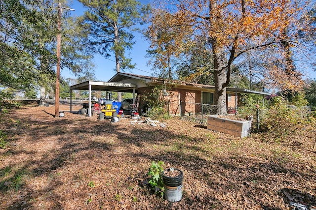 back of house with a carport