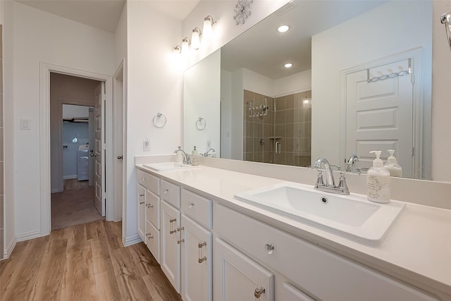 bathroom featuring vanity, wood-type flooring, and a shower with shower door