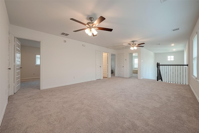 carpeted spare room with ceiling fan