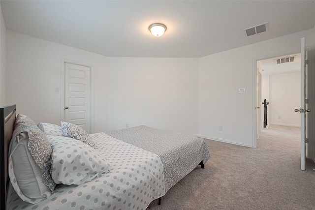 bedroom with light colored carpet and a closet