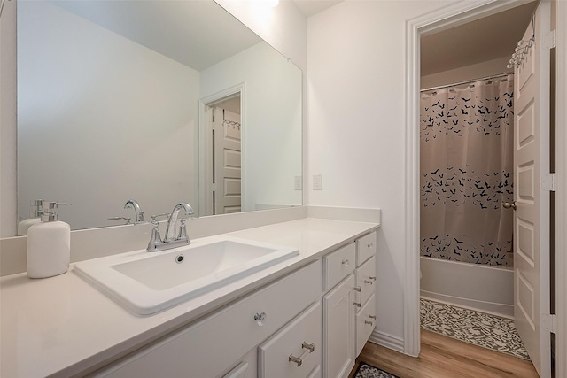 bathroom featuring hardwood / wood-style floors, vanity, and shower / tub combo with curtain