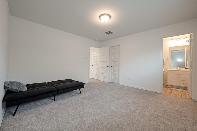 sitting room with light carpet and sink