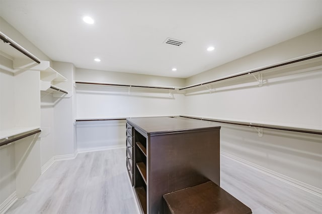 spacious closet with light hardwood / wood-style flooring