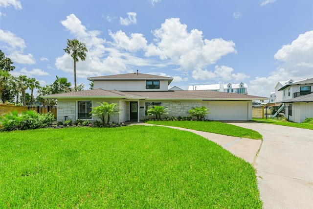 view of front of home featuring a garage and a front yard