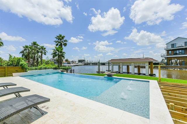 view of swimming pool featuring a patio and a water view