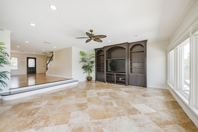 interior space featuring a wealth of natural light, crown molding, and ceiling fan