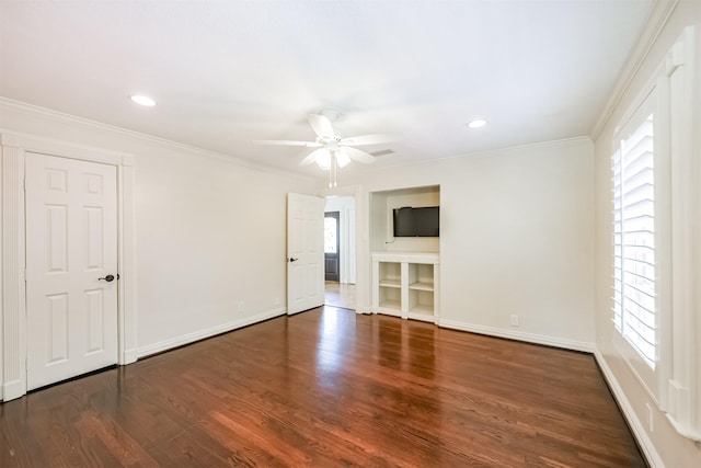 empty room with ceiling fan, dark hardwood / wood-style flooring, and crown molding