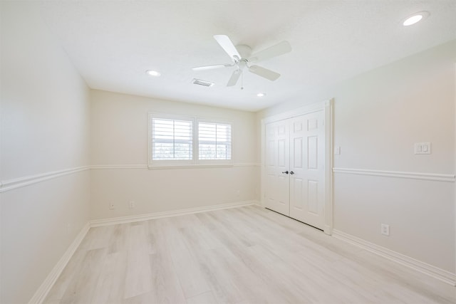 unfurnished bedroom with a closet, ceiling fan, and light hardwood / wood-style flooring