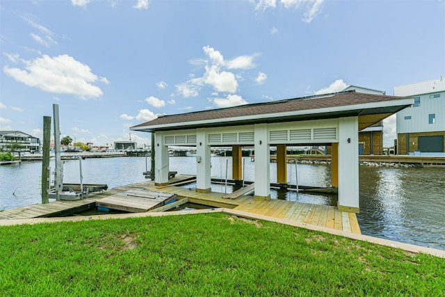 dock area with a yard and a water view