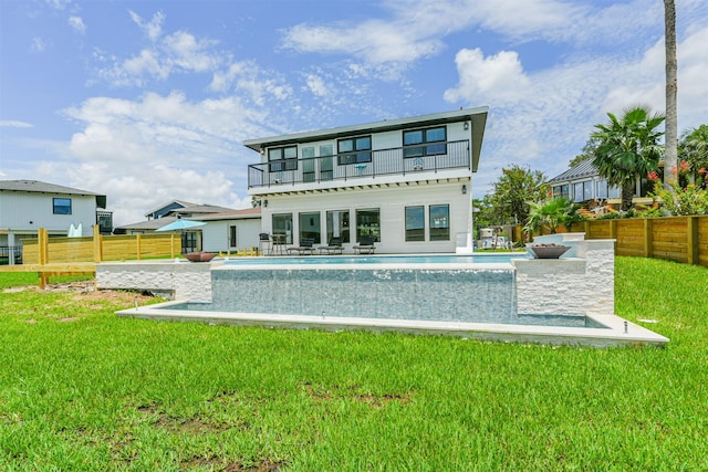 back of house with a lawn, a balcony, a fenced in pool, and a patio