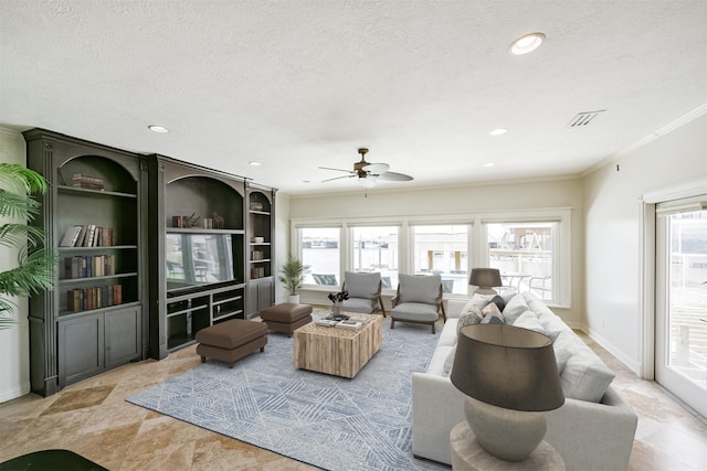 living room featuring ceiling fan, a healthy amount of sunlight, crown molding, and a textured ceiling