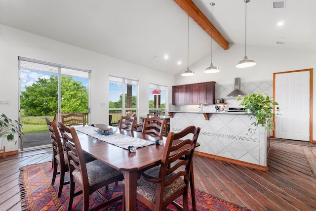 dining space featuring dark hardwood / wood-style flooring and lofted ceiling with beams