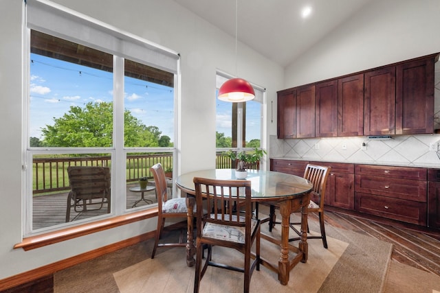 dining room featuring lofted ceiling