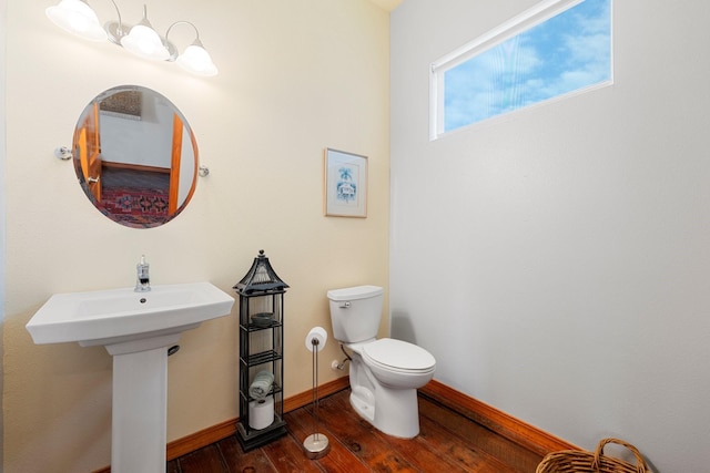 bathroom featuring hardwood / wood-style floors, toilet, and sink