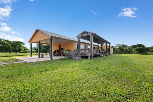 back of property featuring a deck and a lawn