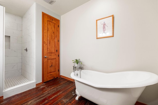 bathroom featuring plus walk in shower and wood-type flooring