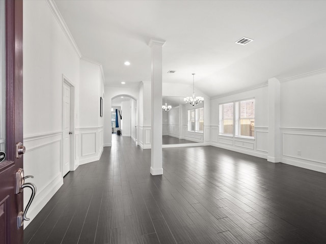 interior space with crown molding, dark hardwood / wood-style floors, and an inviting chandelier