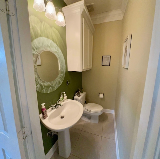 bathroom featuring toilet, sink, tile patterned flooring, and ornamental molding