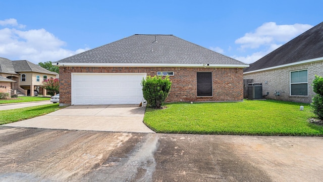 view of front of house with central AC unit, a garage, and a front yard