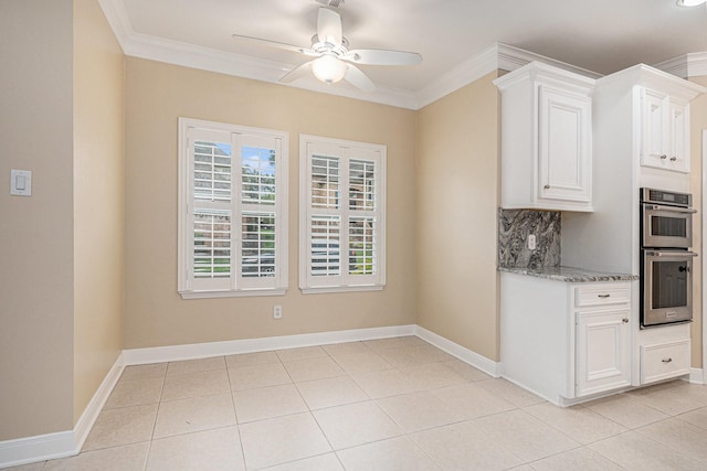 kitchen with white cabinets, ceiling fan, double oven, and tasteful backsplash