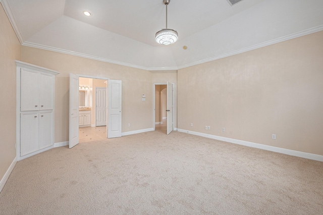 unfurnished bedroom with light carpet, connected bathroom, a raised ceiling, and crown molding