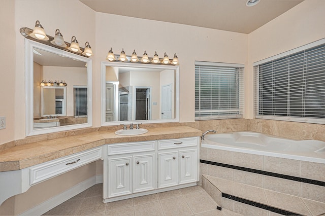 bathroom featuring plus walk in shower, vanity, and tile patterned floors