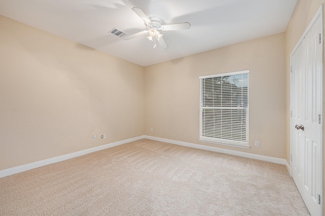 carpeted empty room with ceiling fan