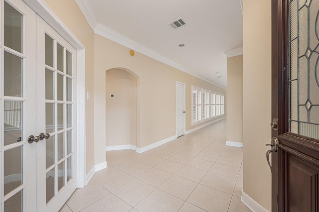 tiled foyer entrance featuring french doors and ornamental molding