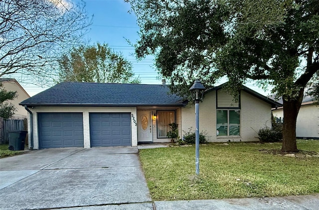 ranch-style home featuring a front yard and a garage