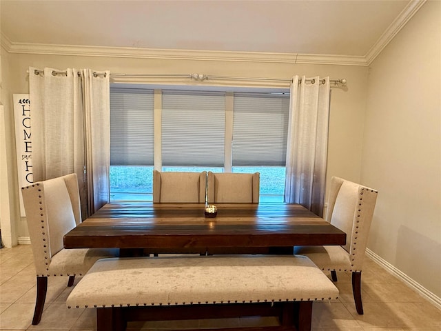 dining space featuring crown molding and light tile patterned flooring