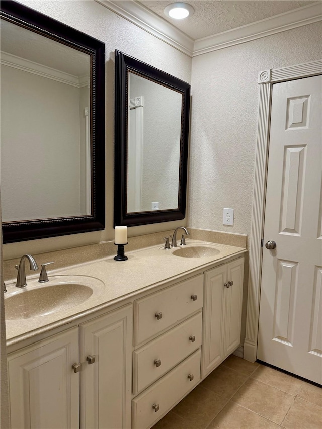 bathroom featuring crown molding, tile patterned flooring, vanity, and a textured ceiling