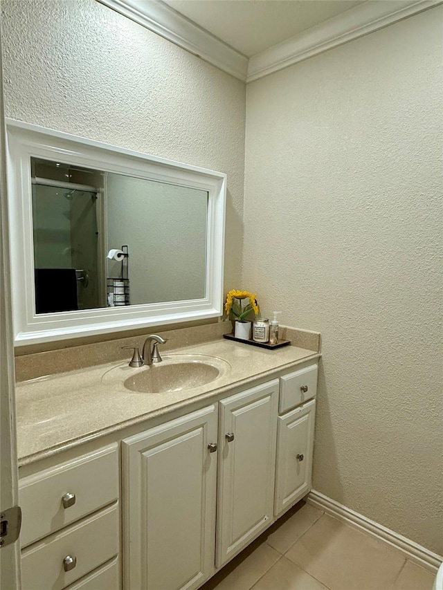 bathroom featuring vanity, tile patterned floors, and crown molding