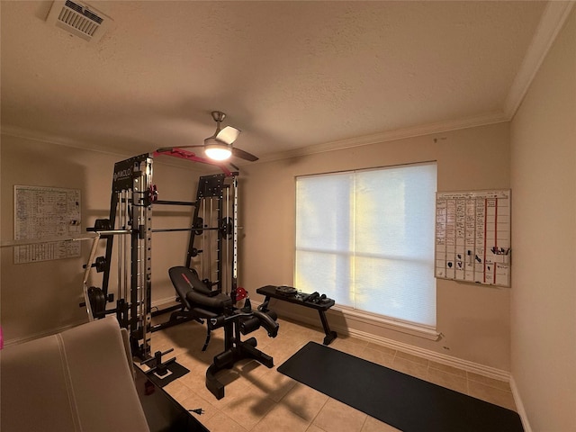 exercise room with a textured ceiling, ceiling fan, and crown molding