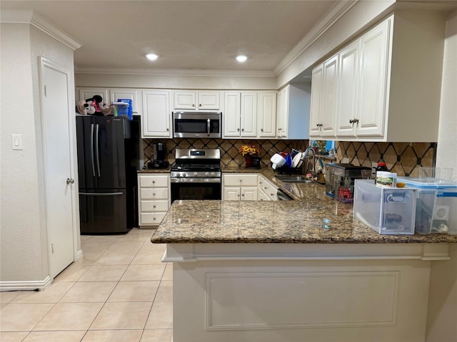 kitchen with kitchen peninsula, appliances with stainless steel finishes, dark stone counters, sink, and light tile patterned floors