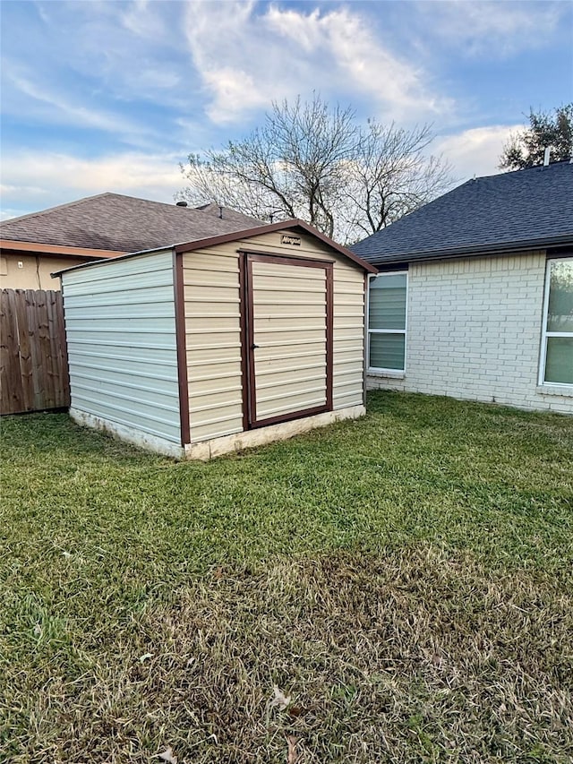 view of outdoor structure featuring a lawn