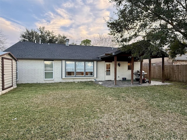 back of house featuring a patio and a lawn