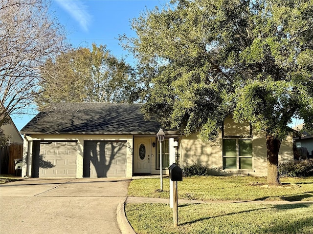 view of front of property featuring a front yard and a garage