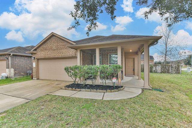 view of front of home featuring covered porch, a garage, and a front yard