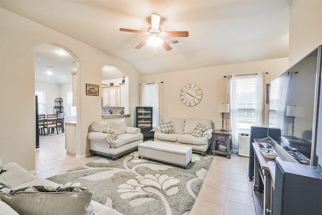 living room featuring light tile patterned floors, ceiling fan, lofted ceiling, and sink