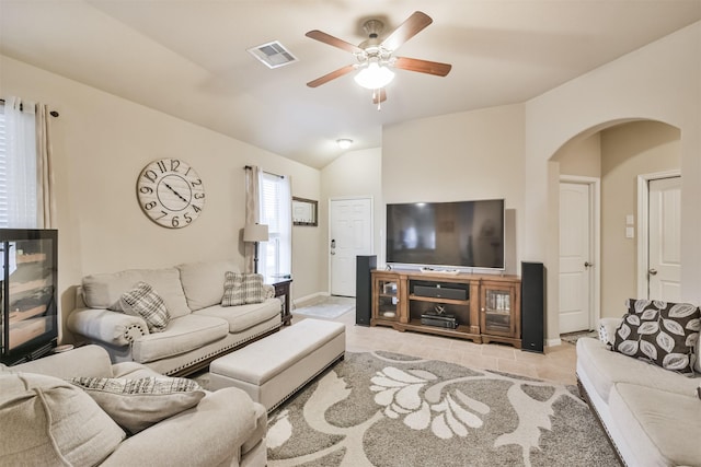 tiled living room featuring ceiling fan and vaulted ceiling