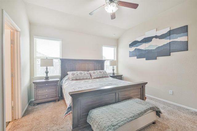 bedroom featuring multiple windows, ceiling fan, light colored carpet, and vaulted ceiling