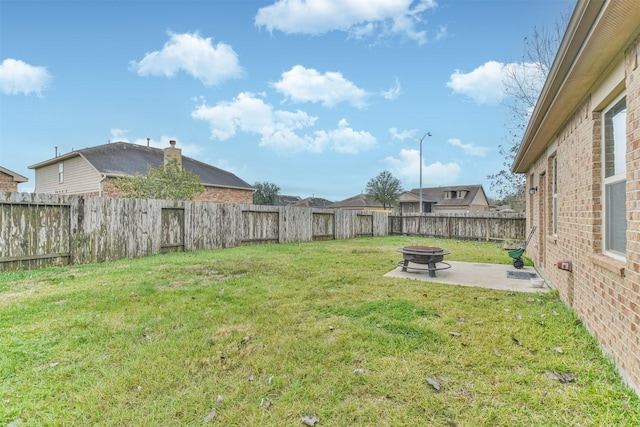 view of yard featuring a fire pit and a patio area