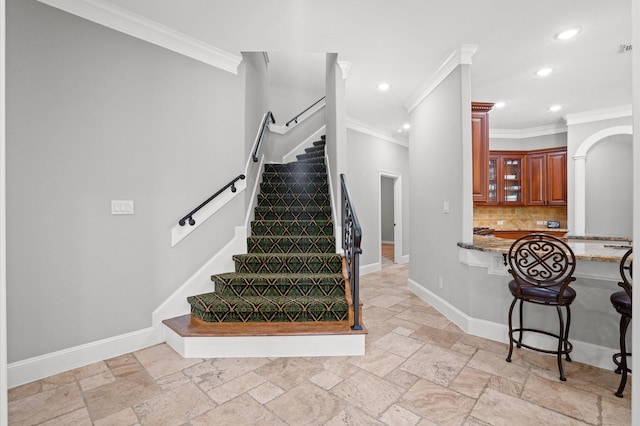 stairway featuring crown molding