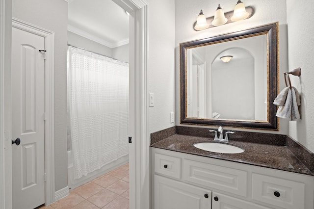 bathroom with tile patterned floors, crown molding, and vanity