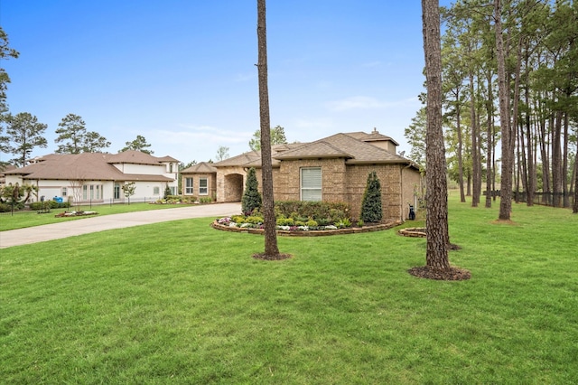 ranch-style home with a front lawn