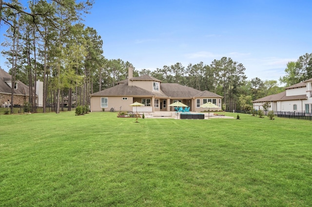 back of house with an outdoor living space, a yard, and a patio