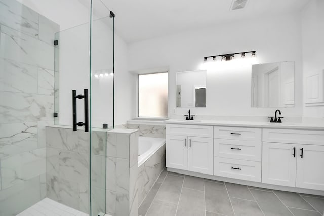 bathroom featuring tile patterned flooring, vanity, and shower with separate bathtub