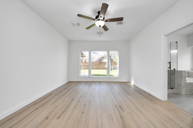 empty room featuring ceiling fan and light hardwood / wood-style flooring